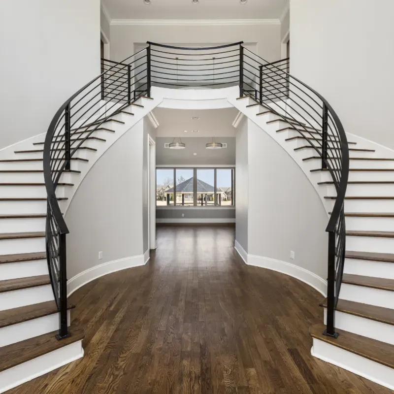 Custom home interior entry way with double staircase.