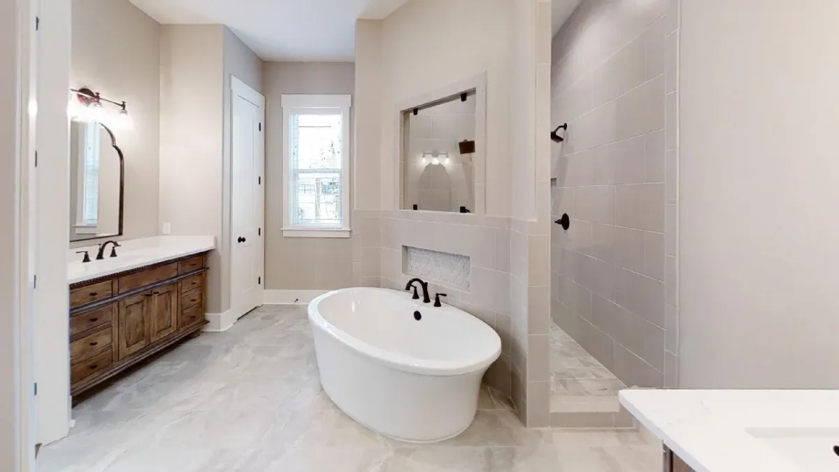 Beutiful bathroom and large tub with a shower that is inset behind.