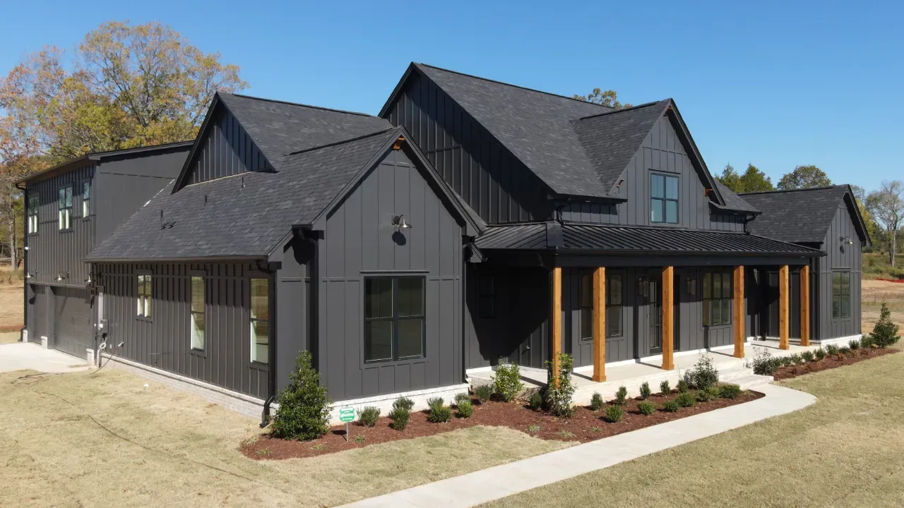 Modern custom home dark exterior with stained wood beams.