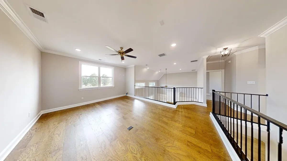 Custom home in Pebble Ridge showing large loft and iron works.