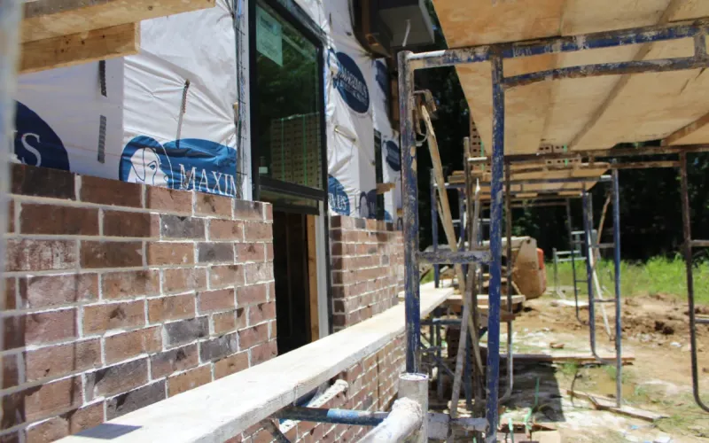 Home construction showing brick phase.