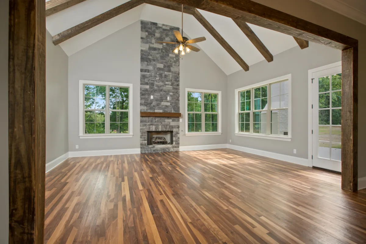 Custom home with oak floors and ceiling support beams.